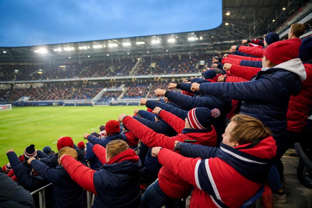 Tifosi in rosso e blu durante una coreografia stile Viking Row allo stadio
